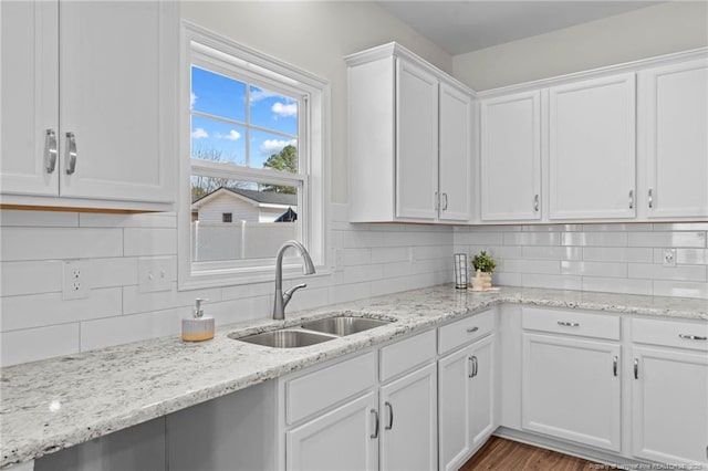 60 Bennett Rd, Coats, NC 27521 - kitchen with a sink, white cabinetry, tasteful backsplash, light stone counters, and wood finished floors