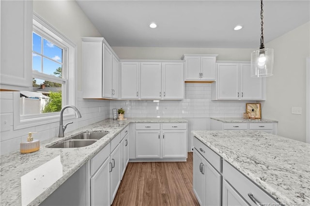 60 Bennett Rd, Coats, NC 27521 - kitchen featuring a sink, white cabinetry, light stone countertops, wood finished floors, and recessed lighting