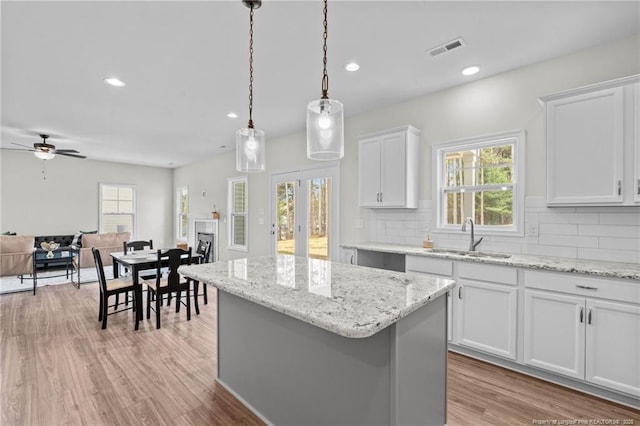 60 Bennett Rd, Coats, NC 27521 - kitchen with a sink, decorative backsplash, a center island, light wood-style floors, and recessed lighting
