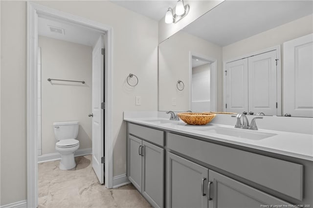 60 Bennett Rd, Coats, NC 27521 - bathroom with double vanity, toilet, baseboards, and marble finish flooring