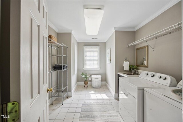 2725 Rosedale Ave, Raleigh, NC 27607 - laundry area with washer and dryer, light tile patterned floors, ornamental molding, and baseboards