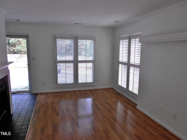 1402 Barton Place Dr, Raleigh, NC 27608 - unfurnished living room with wood finished floors, ornamental molding, a fireplace, baseboards, and a textured ceiling