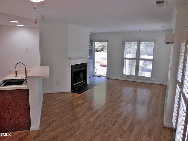 1402 Barton Place Dr, Raleigh, NC 27608 - unfurnished living room featuring a sink, a fireplace, wood finished floors, and baseboards