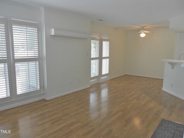 1402 Barton Place Dr, Raleigh, NC 27608 - unfurnished room featuring a ceiling fan, ornamental molding, light wood finished floors, and baseboards
