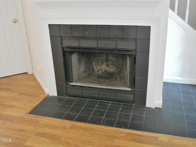 1402 Barton Place Dr, Raleigh, NC 27608 - detailed view of a fireplace, baseboards, and wood finished floors