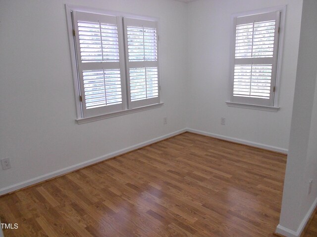 1402 Barton Place Dr, Raleigh, NC 27608 - unfurnished room with wood finished floors and plenty of natural light
