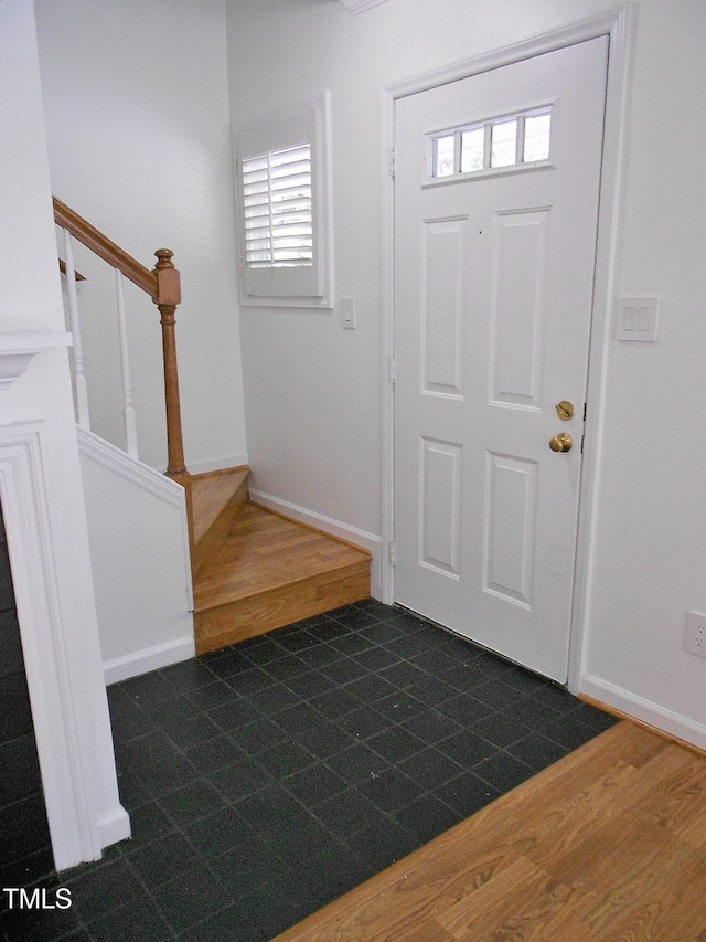 1402 Barton Place Dr, Raleigh, NC 27608 - entrance foyer featuring stairs, dark wood finished floors, and baseboards
