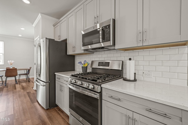 5430 Crescent Square St, Raleigh, NC 27616 - kitchen featuring appliances with stainless steel finishes, crown molding, backsplash, recessed lighting, and light stone counters