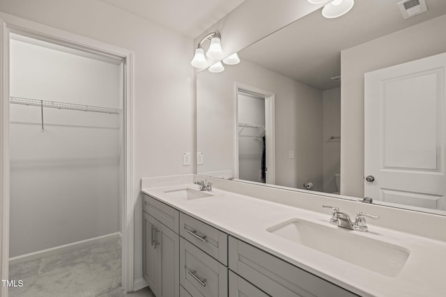 5430 Crescent Square St, Raleigh, NC 27616 - bathroom with double vanity, a spacious closet, toilet, and baseboards