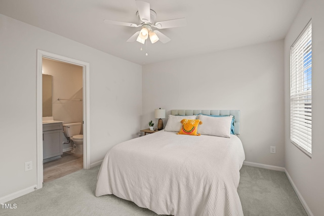 5430 Crescent Square St, Raleigh, NC 27616 - bedroom featuring light colored carpet, connected bathroom, baseboards, and ceiling fan