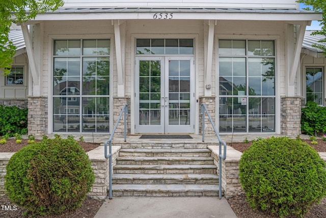5430 Crescent Square St, Raleigh, NC 27616 - entrance to property featuring french doors, a standing seam roof, metal roof, a porch, and stone siding