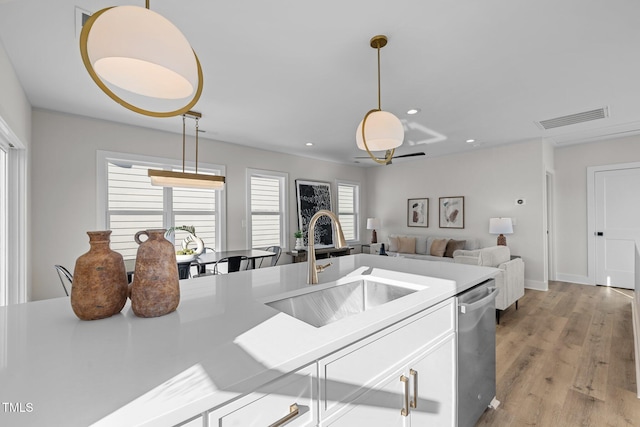 517 Coleman St, Raleigh, NC 27610 - kitchen with a sink, dishwasher, pendant lighting, white cabinets, and light countertops
