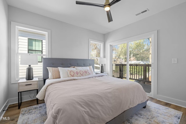 517 Coleman St, Raleigh, NC 27610 - bedroom featuring access to exterior, multiple windows, baseboards, and wood finished floors