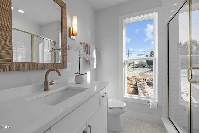 517 Coleman St, Raleigh, NC 27610 - bathroom with vanity, toilet, a shower stall, speckle patterned floor, and recessed lighting