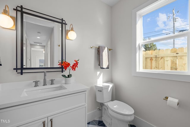517 Coleman St, Raleigh, NC 27610 - bathroom featuring baseboards, toilet, vanity, and tile patterned flooring