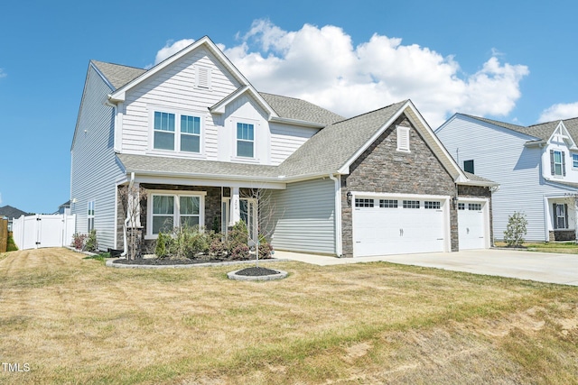 254 Arlie Ln, Lillington, NC 27546 - craftsman house with a gate, stone siding, concrete driveway, an attached garage, and roof with shingles