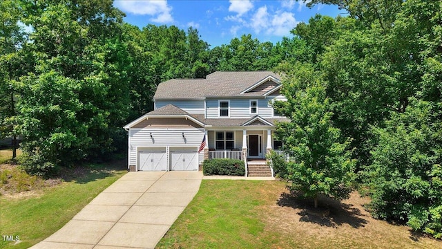 1304 Double Oak Ln, Willow Springs, NC 27592 - craftsman inspired home featuring a porch, a front lawn, driveway, and a garage