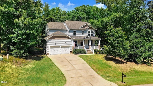 1304 Double Oak Ln, Willow Springs, NC 27592 - view of front of home featuring a porch, a front lawn, driveway, an attached garage, and roof with shingles