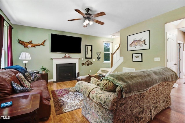 1304 Double Oak Ln, Willow Springs, NC 27592 - living room featuring ceiling fan, stairway, wood finished floors, and a fireplace with flush hearth