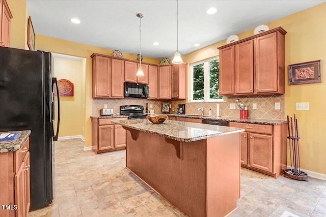 1304 Double Oak Ln, Willow Springs, NC 27592 - kitchen with black appliances, a center island, light stone countertops, a kitchen breakfast bar, and baseboards