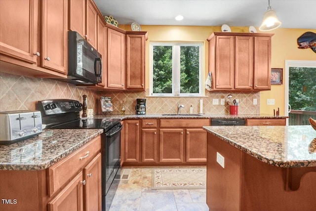1304 Double Oak Ln, Willow Springs, NC 27592 - kitchen featuring black appliances, a sink, light stone counters, and brown cabinets