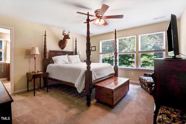 1304 Double Oak Ln, Willow Springs, NC 27592 - bedroom with light carpet, baseboards, ensuite bath, and a ceiling fan