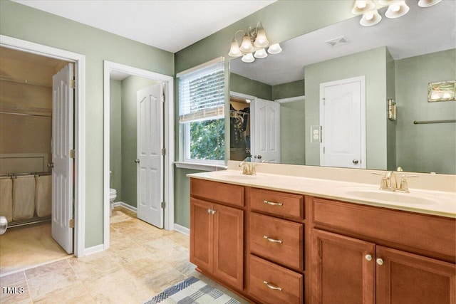 1304 Double Oak Ln, Willow Springs, NC 27592 - bathroom with double vanity, toilet, baseboards, and tile patterned floors