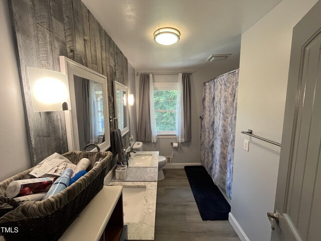 2433 Zacks Mill Rd, Angier, NC 27501 - bathroom featuring toilet, vanity, baseboards, wood finished floors, and a shower with shower curtain