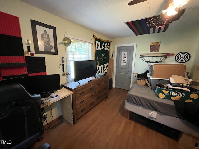 2433 Zacks Mill Rd, Angier, NC 27501 - bedroom with wood finished floors, a desk, ceiling fan, and a textured ceiling