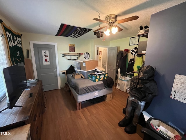 2433 Zacks Mill Rd, Angier, NC 27501 - bedroom featuring wood finished floors, a ceiling fan, and a textured ceiling