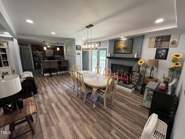 2433 Zacks Mill Rd, Angier, NC 27501 - dining space featuring crown molding, dark wood-style floors, a fireplace, recessed lighting, and baseboards