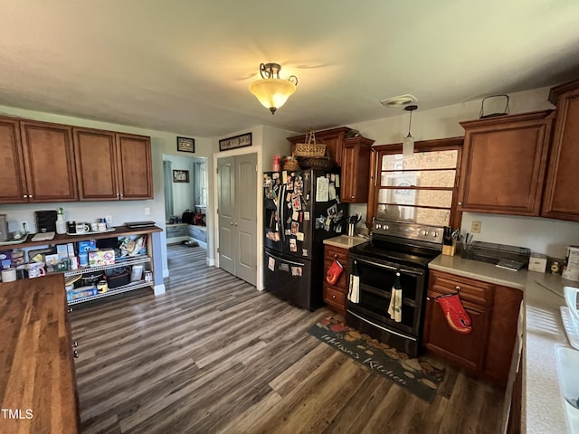 2433 Zacks Mill Rd, Angier, NC 27501 - kitchen featuring black fridge with ice dispenser, range with two ovens, dark wood-type flooring, light countertops, and decorative light fixtures