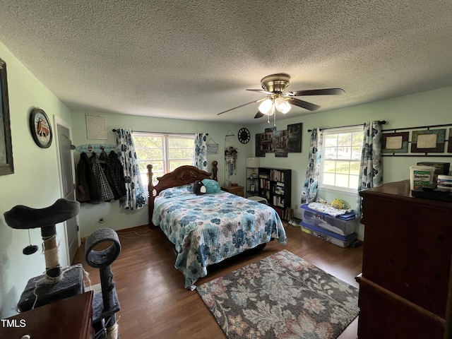 2433 Zacks Mill Rd, Angier, NC 27501 - bedroom with multiple windows, wood finished floors, ceiling fan, and a textured ceiling