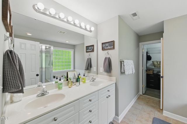 2933 Creek Moss Ave, Wake Forest, NC 27587 - full bathroom with double vanity, tile patterned floors, and a shower with shower door