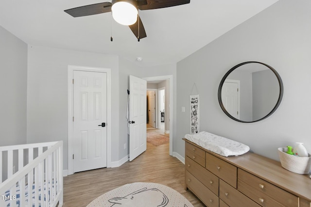 2933 Creek Moss Ave, Wake Forest, NC 27587 - bedroom featuring light wood-style floors, a ceiling fan, and a nursery area