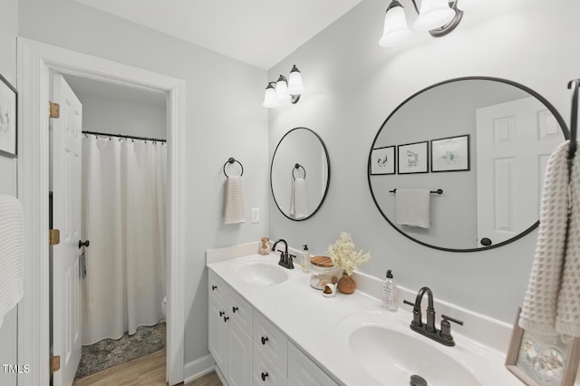 2933 Creek Moss Ave, Wake Forest, NC 27587 - bathroom with double vanity, wood finished floors, and a shower with curtain