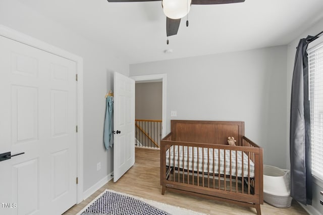 2933 Creek Moss Ave, Wake Forest, NC 27587 - bedroom with wood finished floors, ceiling fan, and a crib