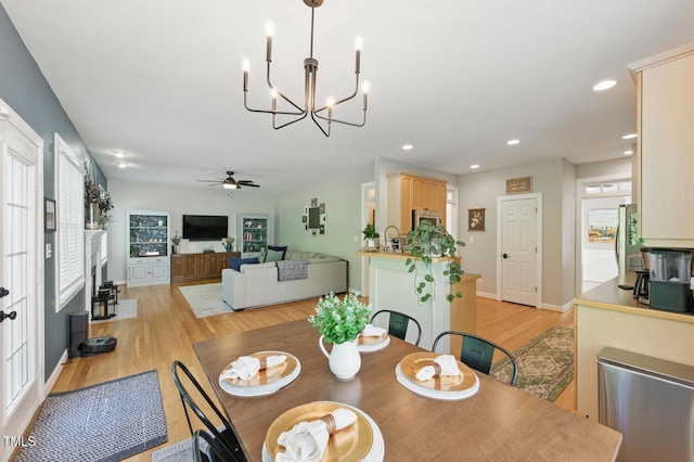 2933 Creek Moss Ave, Wake Forest, NC 27587 - dining space featuring light wood-type flooring, a ceiling fan, a chandelier, and recessed lighting