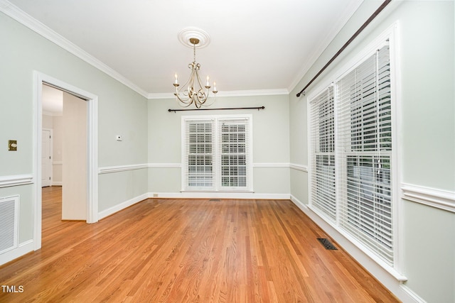 7605 Sandy Lake Ct, Raleigh, NC 27613 - empty room with a chandelier, crown molding, and light wood-style flooring