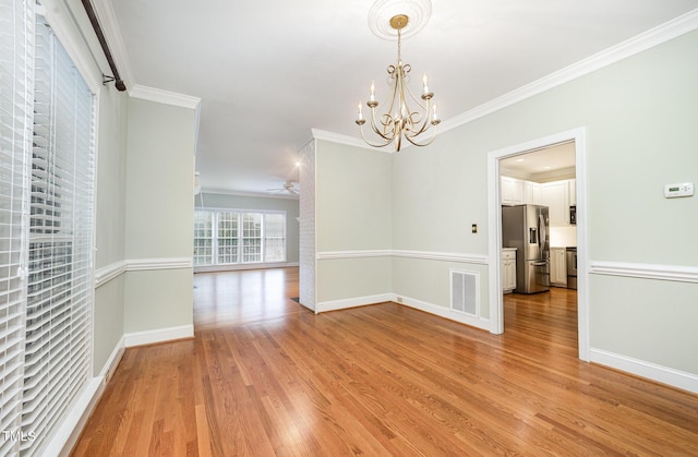 7605 Sandy Lake Ct, Raleigh, NC 27613 - unfurnished room featuring crown molding, a chandelier, light wood-style flooring, and a ceiling fan