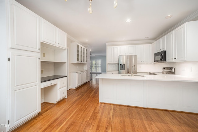 7605 Sandy Lake Ct, Raleigh, NC 27613 - kitchen with black microwave, stainless steel fridge, range with electric cooktop, built in desk, and a peninsula