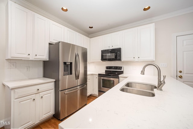 7605 Sandy Lake Ct, Raleigh, NC 27613 - kitchen with stainless steel appliances, light stone counters, white cabinets, ornamental molding, and backsplash