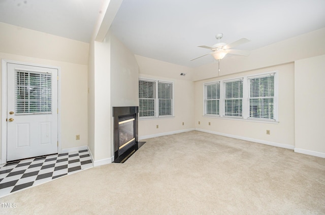 7605 Sandy Lake Ct, Raleigh, NC 27613 - unfurnished living room with a ceiling fan, light colored carpet, and a fireplace with flush hearth