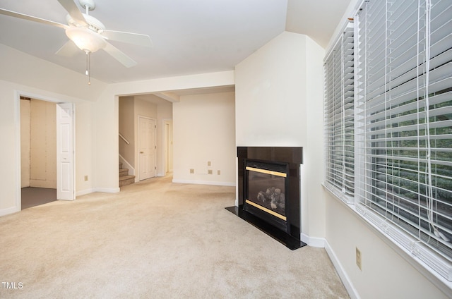 7605 Sandy Lake Ct, Raleigh, NC 27613 - unfurnished living room featuring ceiling fan, carpet floors, a multi sided fireplace, and stairs