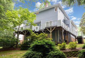 7605 Sandy Lake Ct, Raleigh, NC 27613 - back of property with a deck and a chimney