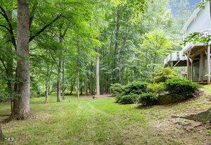 7605 Sandy Lake Ct, Raleigh, NC 27613 - view of green lawn featuring a forest view