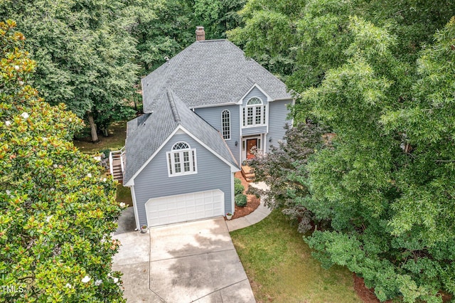 7605 Sandy Lake Ct, Raleigh, NC 27613 - traditional home featuring roof with shingles, concrete driveway, a garage, and a chimney