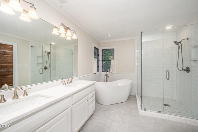 7605 Sandy Lake Ct, Raleigh, NC 27613 - bathroom featuring a shower stall, double vanity, a soaking tub, ornamental molding, and recessed lighting