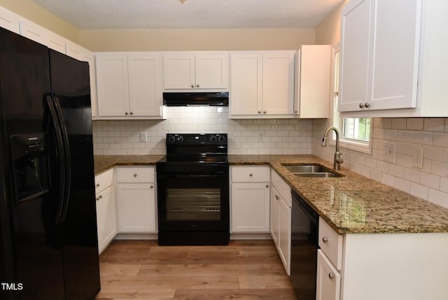 5949 Sandy Run, Knightdale, NC 27545 - kitchen featuring black appliances, under cabinet range hood, a sink, light wood finished floors, and white cabinetry