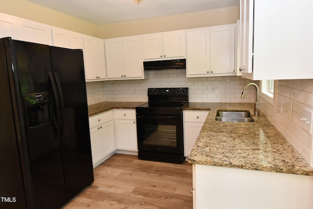 5949 Sandy Run, Knightdale, NC 27545 - kitchen with black appliances, a sink, under cabinet range hood, white cabinetry, and a textured ceiling